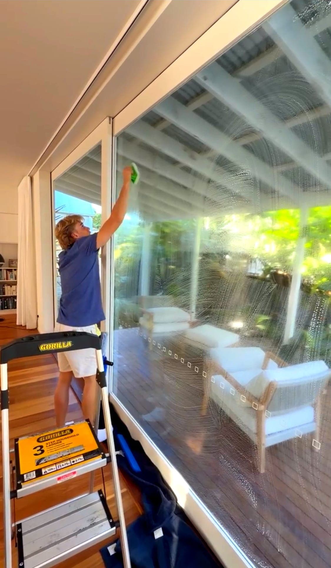 Squeegee Bros cleaning a large picture window in Brisbane