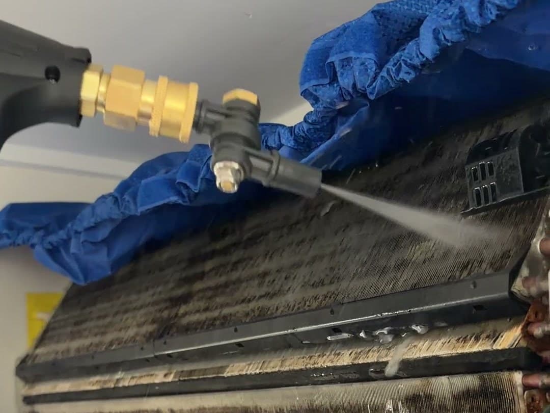 Washing the dirty coil of a split system aircon on a real Brisbane job, a cleaning bag fitted underneath