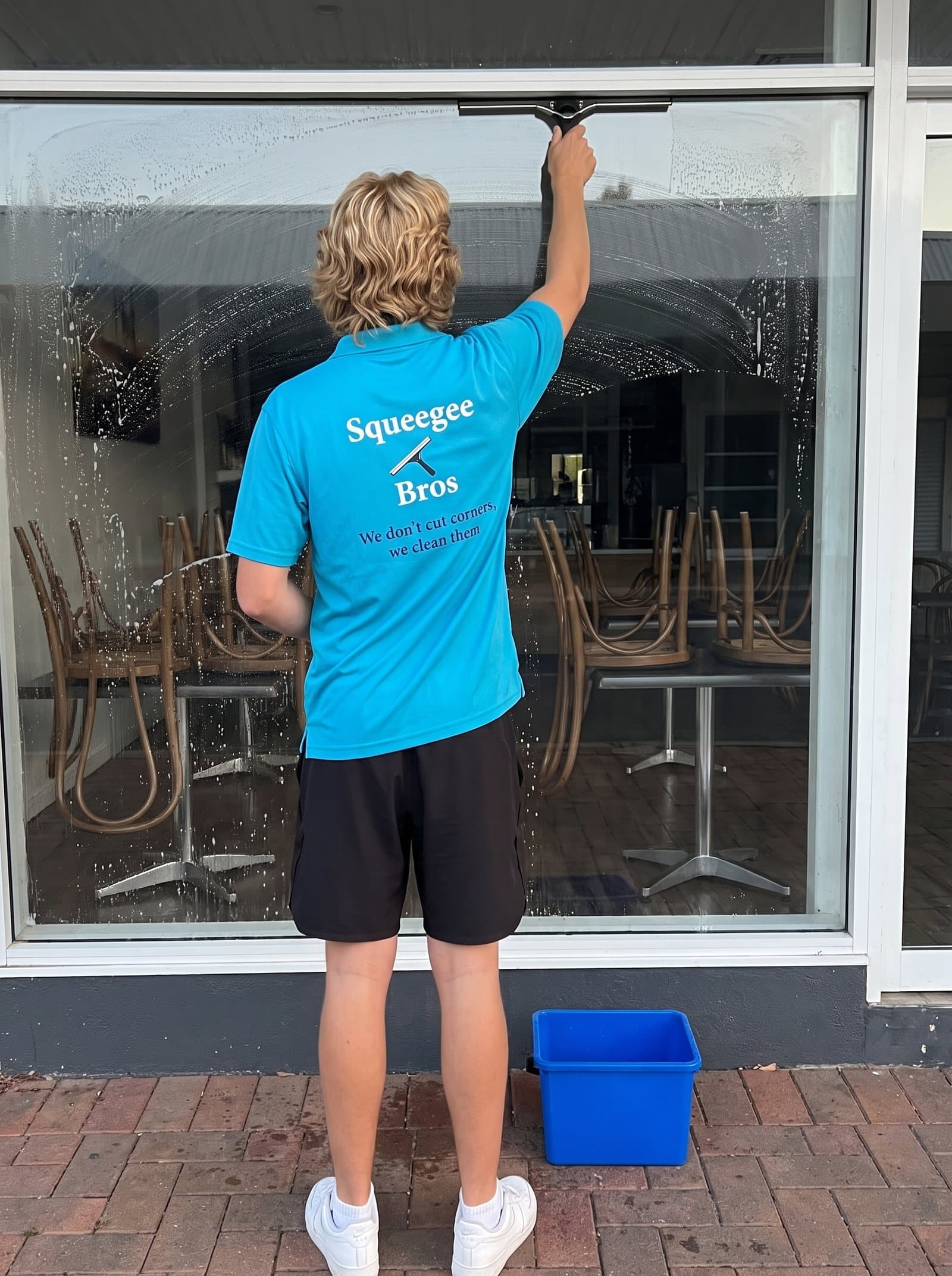 Squeegee Bros cleaning a café shopfront in Brisbane before opening