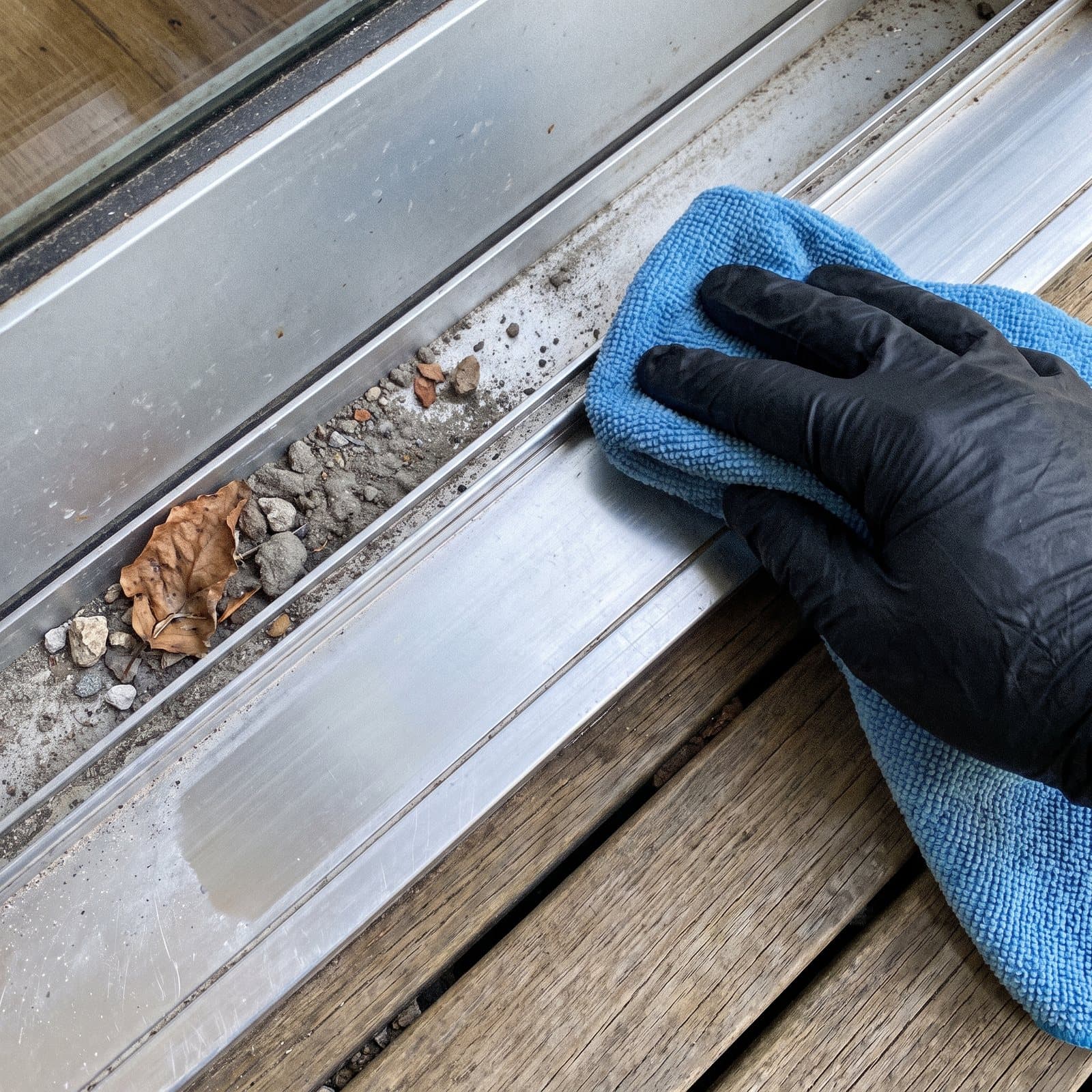 Detailing a window sill and track with a microfibre cloth