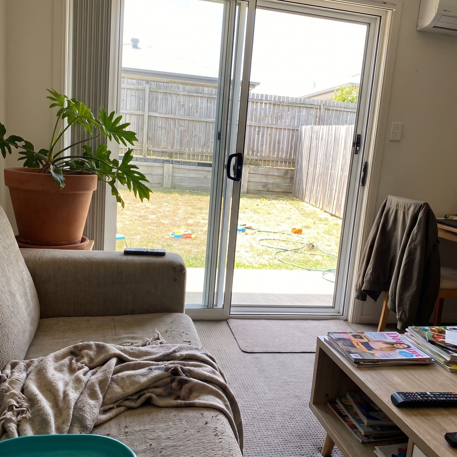 Looking out through freshly cleaned glass doors onto a deck and garden